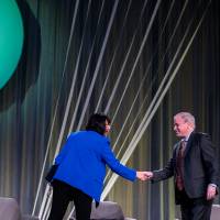 President Mantella and Dr. Paul Isely shaking hands at the West Michigan Economic Forecast